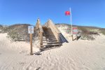The Mayan Princess beach boardwalk and rip current warning flag